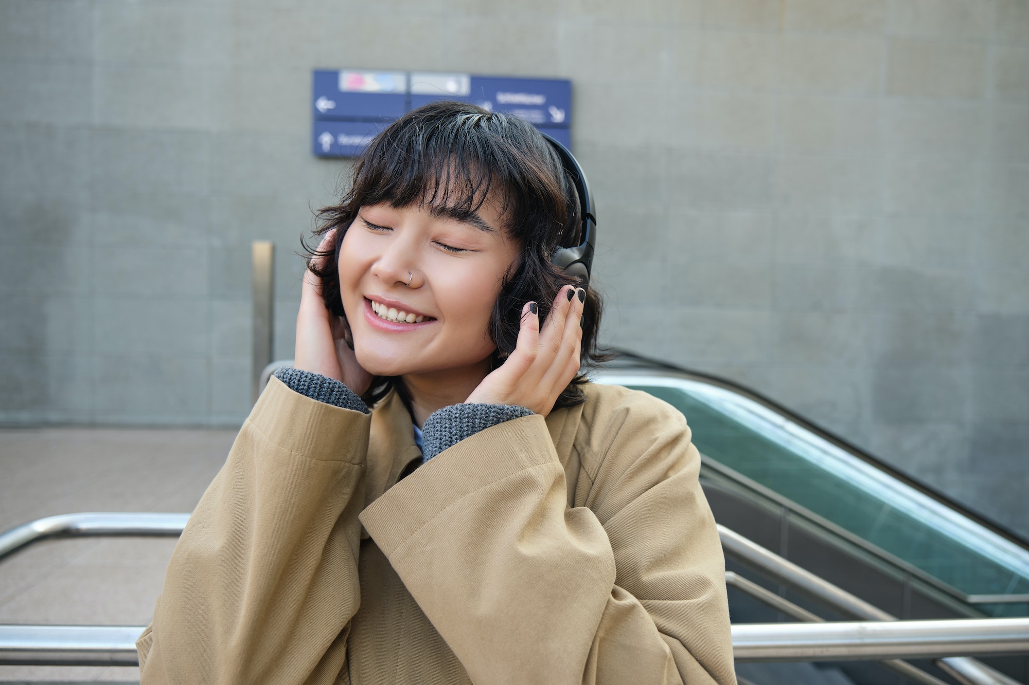 portrait-of-happy-woman-korean-girl-in-headphones-listening-music-in-headphones-enjoying-sound.jpg