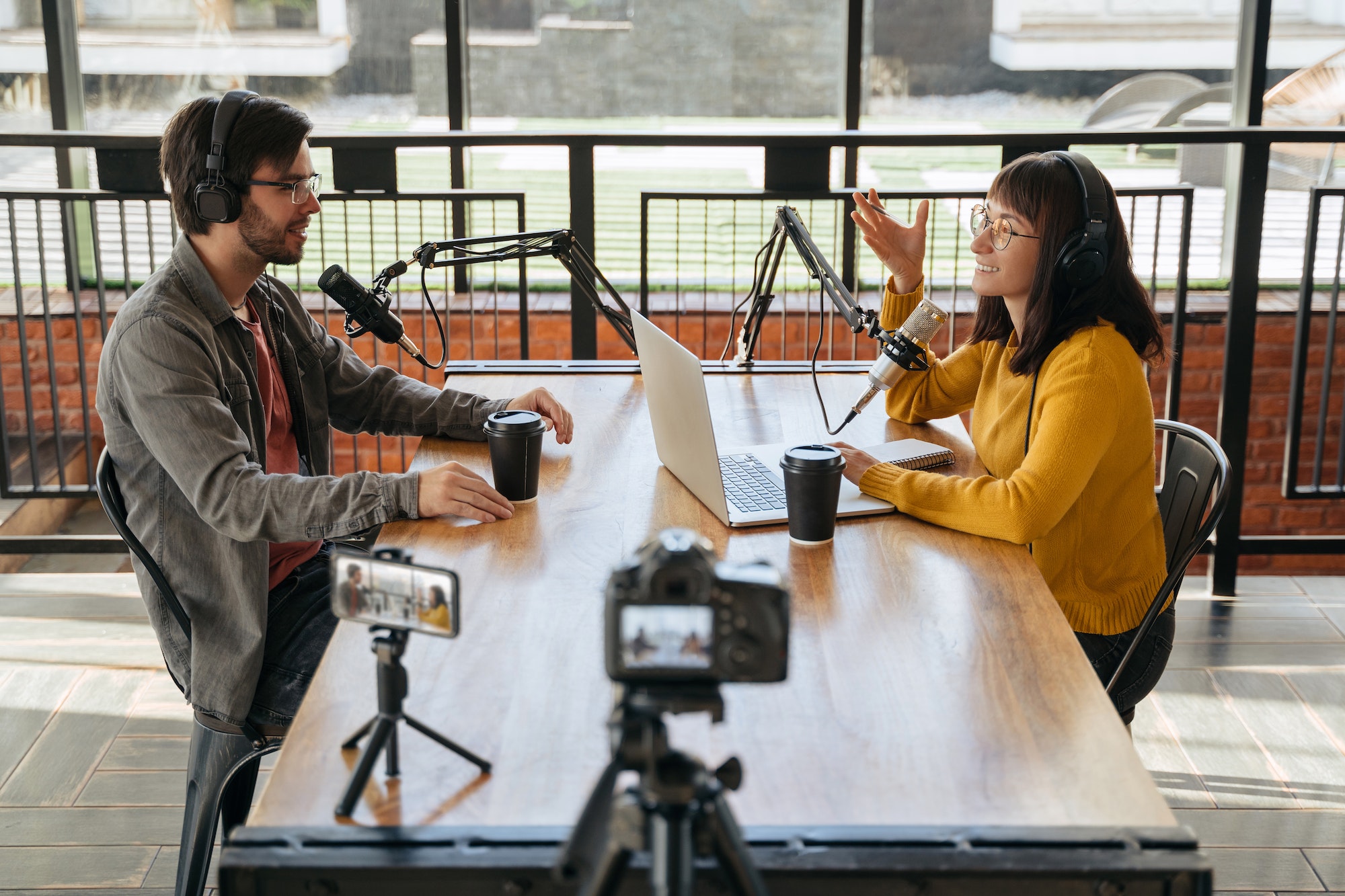 two-podcasters-recording-video-podcast-together-in-studio.jpg
